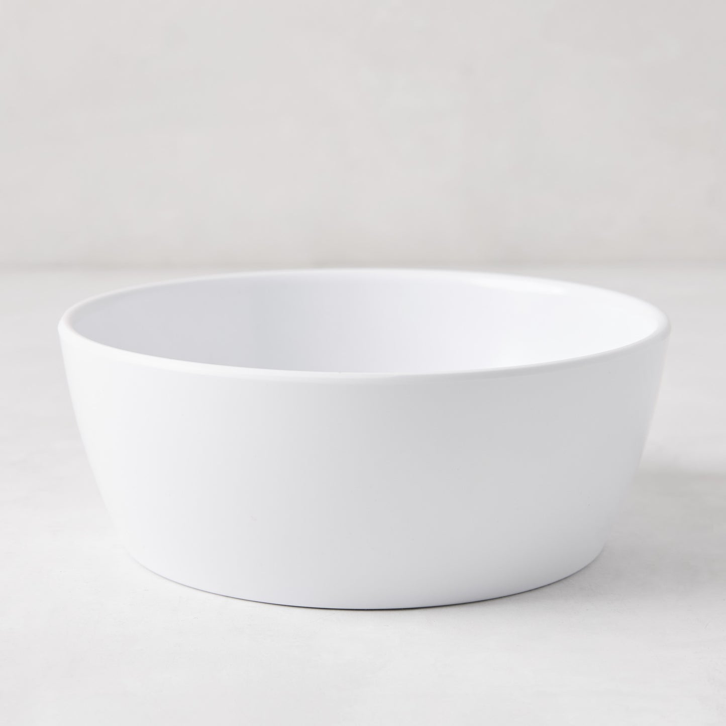 HG White Melamine Bowl, 6.75"Dia x 2.5"H, with a modern lipped design.