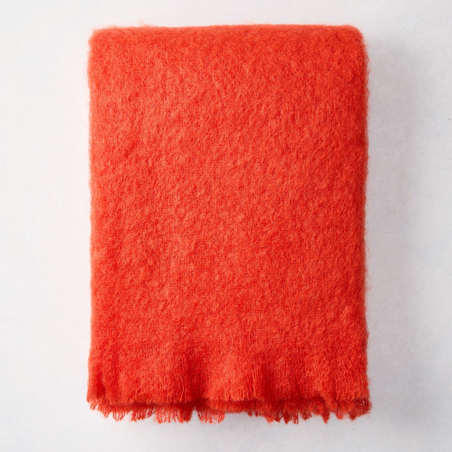 Folded Hibiscus Orange Mohair Throw Blanket, 72"L x 51"W, with a soft, textured finish.