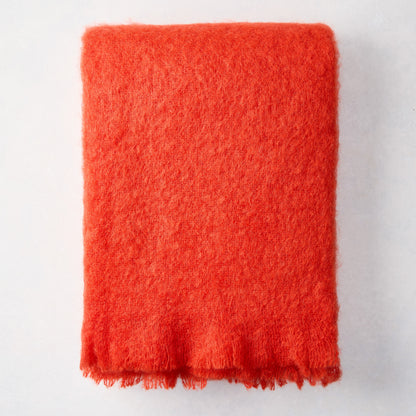 Folded Hibiscus Orange Mohair Throw Blanket, 72"L x 51"W, with a soft, textured finish.