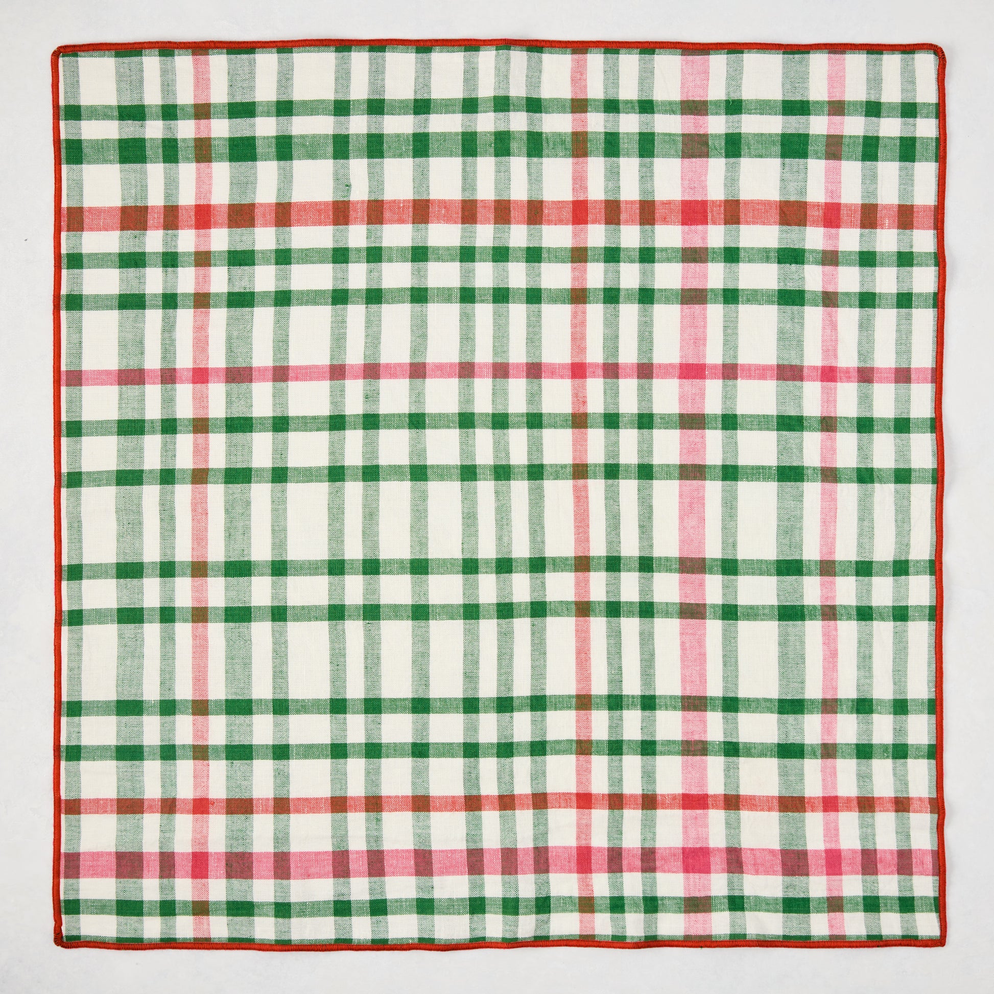 Holiday green and red gingham cotton napkin with embroidered red trim, 22" square.