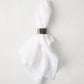 Horn napkin ring with unique natural variations on a white linen napkin.
