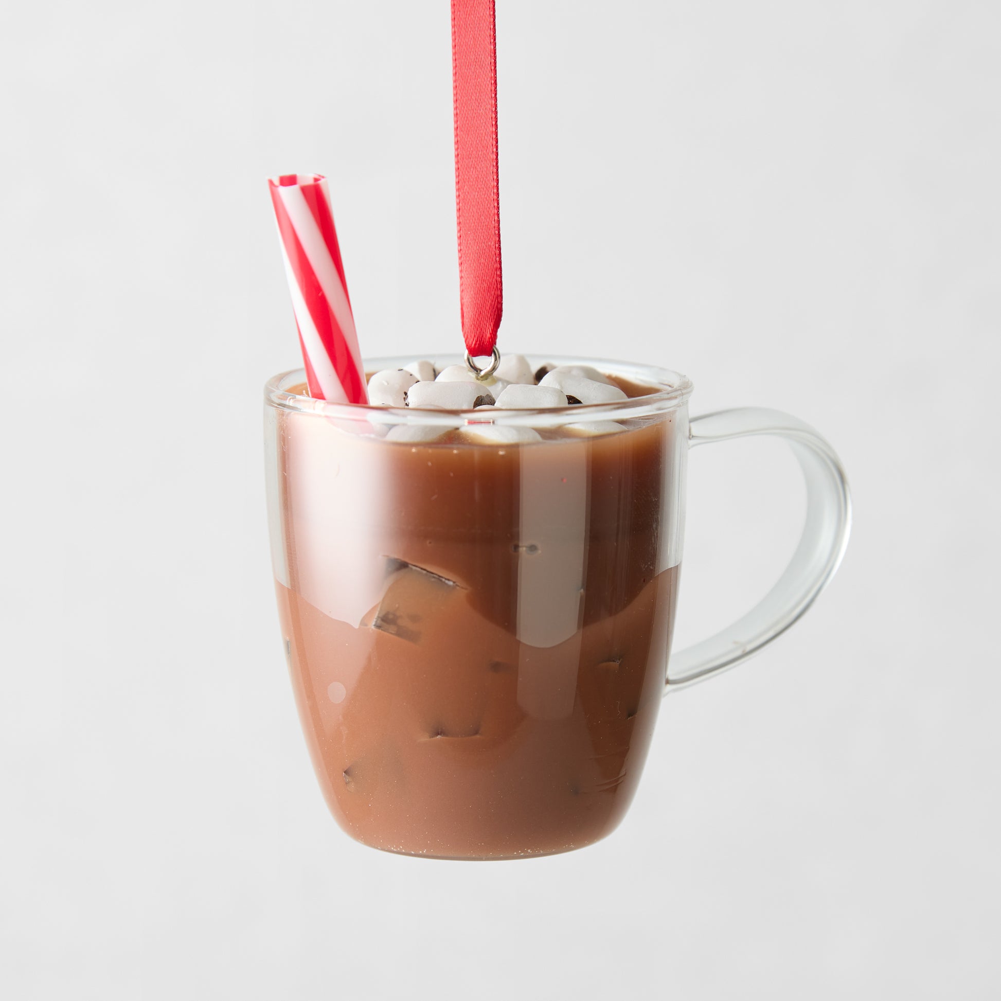 Glass hot cocoa Christmas ornament with marshmallows, peppermint stick, and red ribbon.