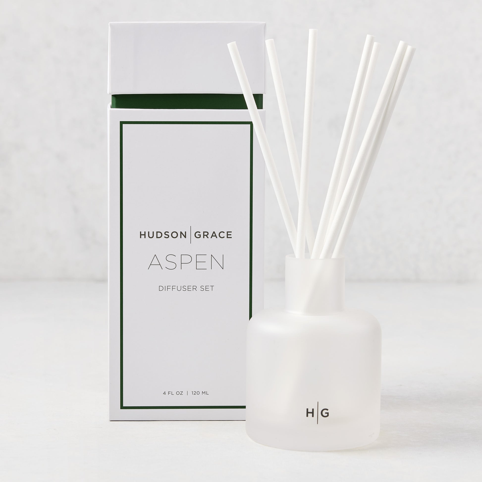 Hudson Grace Aspen 4oz frosted glass reed diffuser set with white reeds and matching box.