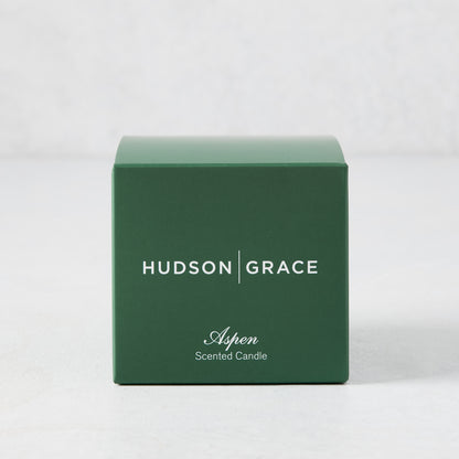 Hudson Grace Aspen Scented Votive candle in a dark green box with white text.