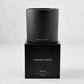 Hudson Grace Bleecker Scented 3-Wick Candle in a matte black glass vessel on its matching black gift box.