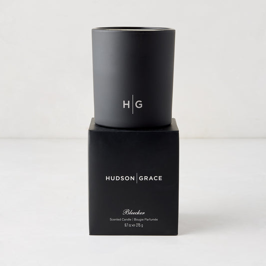 Hudson Grace Bleecker Scented Candle, black matte glass vessel with HG logo, on its black box.
