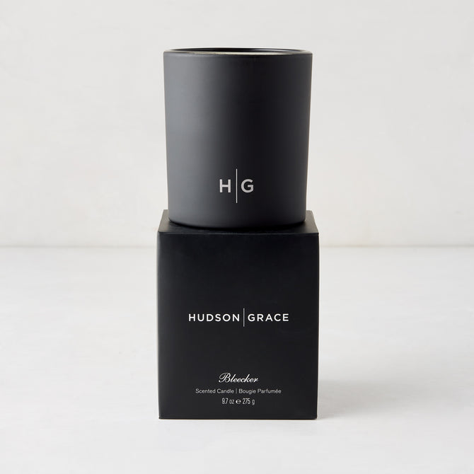 Hudson Grace Bleecker Scented Candle, black matte glass vessel with HG logo, on its black box.