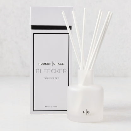 Hudson Grace Bleecker Scented Reed Diffuser set with frosted glass vessel, white reeds, and white box.