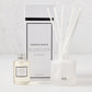 Hudson Grace Bleecker Scented Reed Diffuser set with frosted glass vessel, oil bottle, and white reeds.