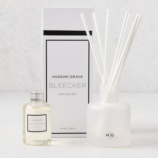 Hudson Grace Bleecker Scented Reed Diffuser set with frosted glass vessel, oil bottle, and white reeds.
