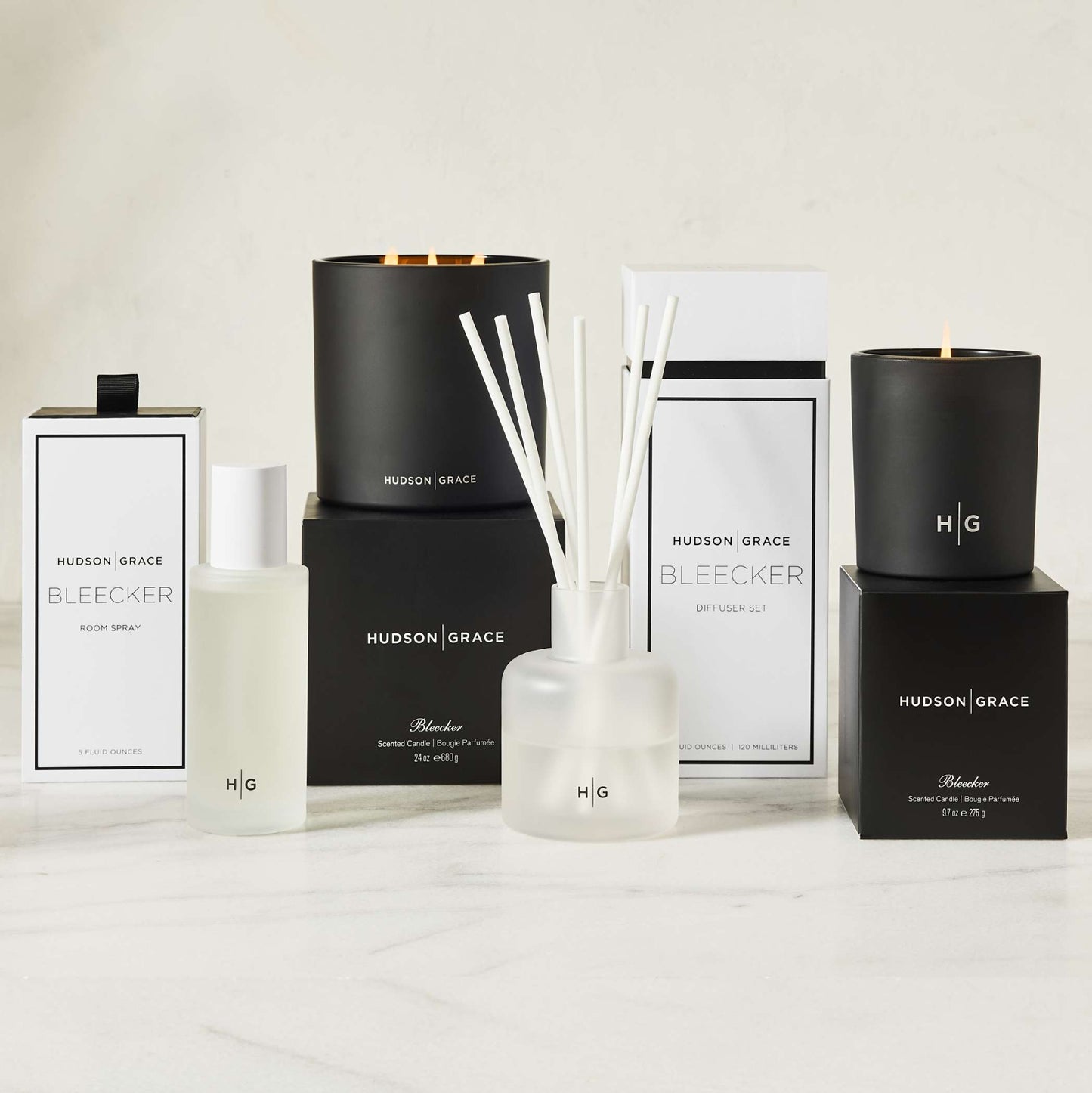 Hudson Grace Bleecker room spray, candles, and diffuser set in black and white packaging.