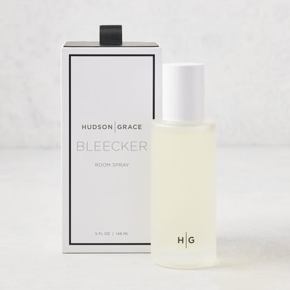 Hudson Grace Bleecker Room Spray: 5.08 oz frosted glass bottle with white cap, next to its white and black box.