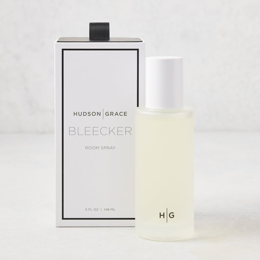 Hudson Grace Bleecker Room Spray: 5.08 oz frosted glass bottle with white cap, next to its white and black box.