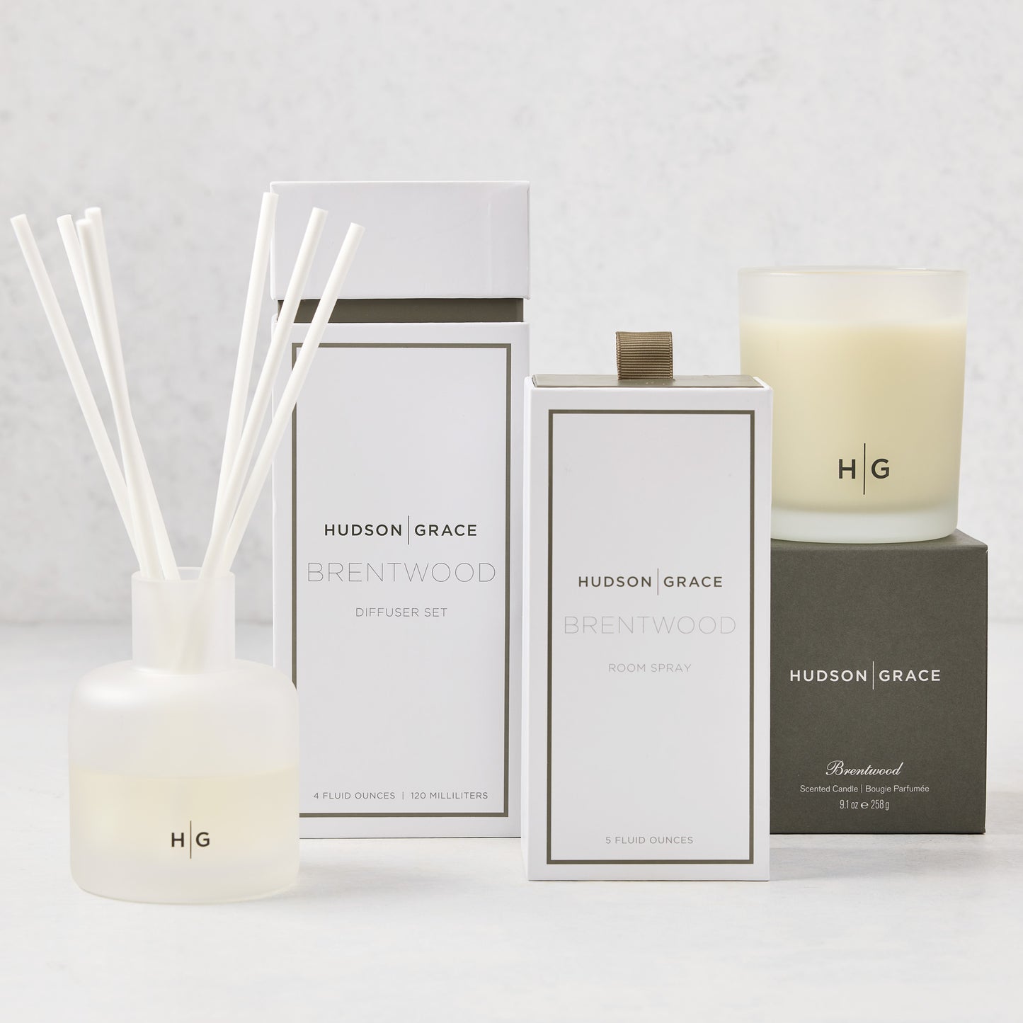 Hudson Grace Brentwood Scent Gift Set: white candle, diffuser with reeds, and room spray in elegant packaging.