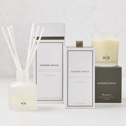 Hudson Grace Brentwood Scent Gift Set: white candle, diffuser with reeds, and room spray in elegant packaging.