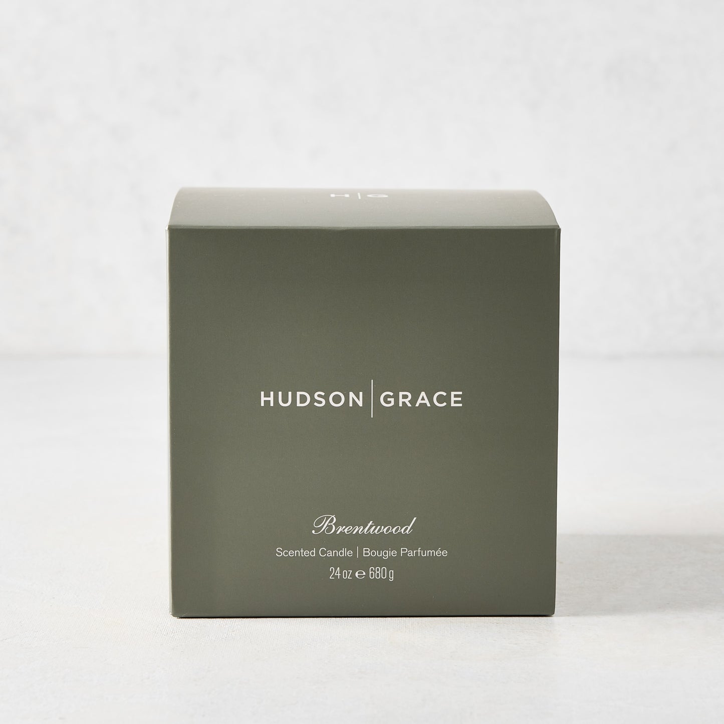 Hudson Grace Brentwood Scented 3-Wick Candle in a dark olive green gift box with white text.
