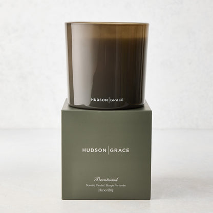 Hudson Grace Brentwood 3-Wick Candle in a dark glass vessel, on its olive green gift box.
