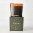 Hudson Grace Brentwood 3-Wick Candle in a dark glass vessel with a matching green gift box.