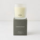 Hudson Grace Brentwood Scented Candle in a frosted glass vessel with HG logo, on a dark gray box.