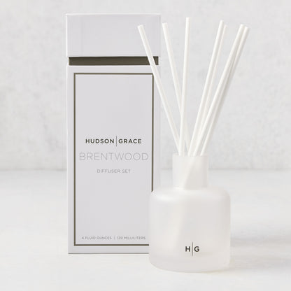 Hudson Grace Brentwood scented reed diffuser set with frosted glass vessel, white reeds, and white box.