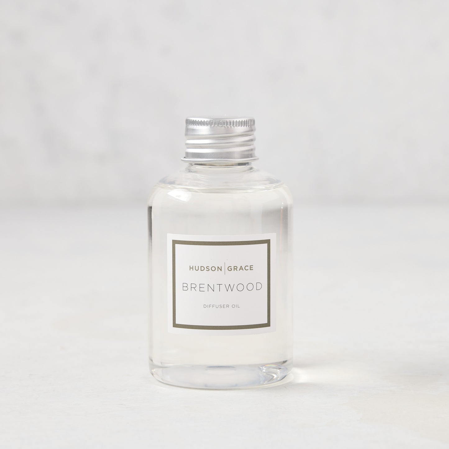 Hudson Grace Brentwood Diffuser Oil Refill, clear glass bottle with silver cap and white label.