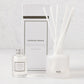 Hudson Grace Brentwood Scented Reed Diffuser set: frosted glass vessel with white reeds, clear oil bottle, and white box.
