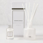 Hudson Grace Brentwood Scented Reed Diffuser set: frosted glass vessel with white reeds, clear oil bottle, and white box.