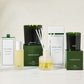 Hudson Grace Aspen collection featuring green glass candles, a reed diffuser, and room spray in white and green packaging.