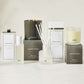 Hudson Grace Brentwood scent collection: room spray, diffuser, and candles in white and dark gray packaging.