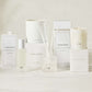 Hudson Grace Greenwich Scent Collection: white candles, diffuser, room spray, and packaging on marble.