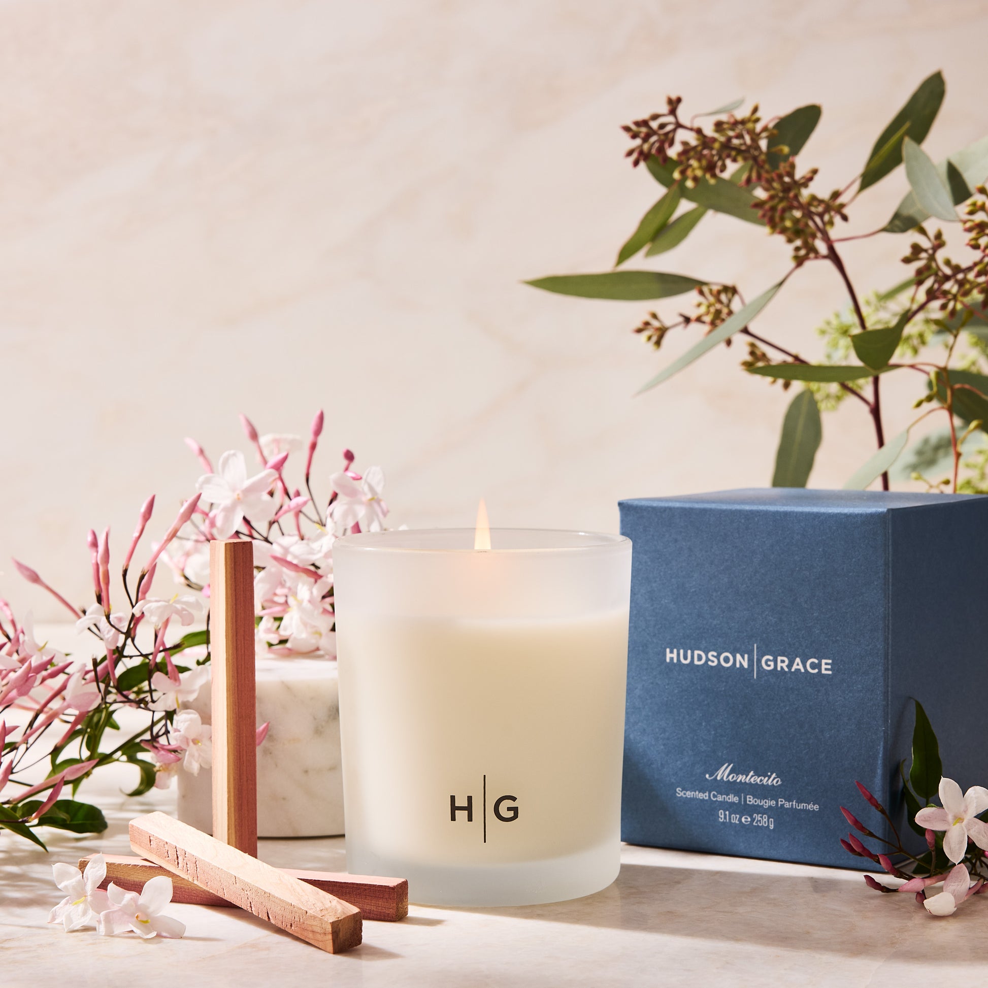 Hudson Grace Montecito scented candle in a frosted glass jar with a blue box, jasmine, and eucalyptus.