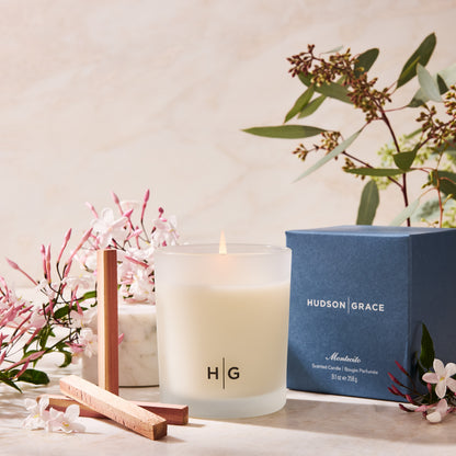 Hudson Grace Montecito scented candle in a frosted glass jar with a blue box, jasmine, and eucalyptus.