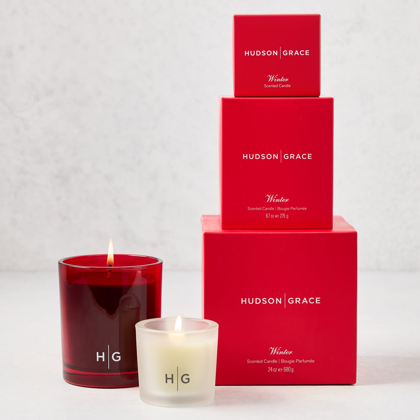 Hudson Grace Winter Candle Gift Set: red glass candle, frosted votive, and three red boxed candles.