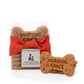 Hudson Grace organic peanut butter dog biscuits, bone-shaped, in a clear bag with an orange ribbon and tag.