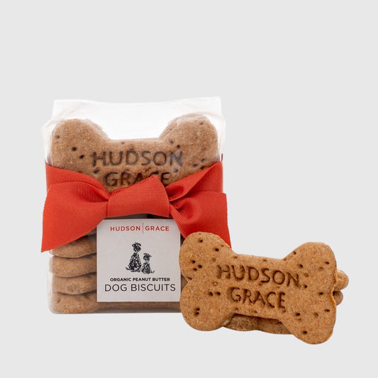 Hudson Grace organic peanut butter dog biscuits in a clear pack with a red ribbon and branded label