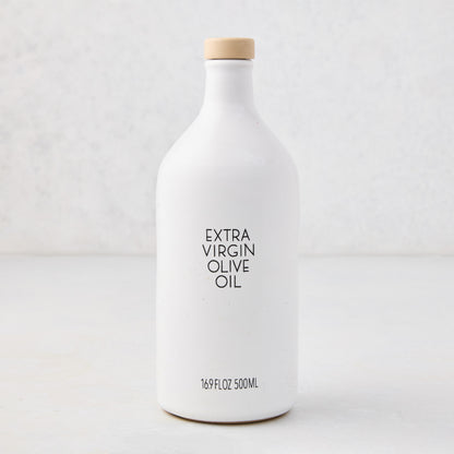 Hudson Grace Extra Virgin Olive Oil in a white ceramic bottle with a wood cork and black label.