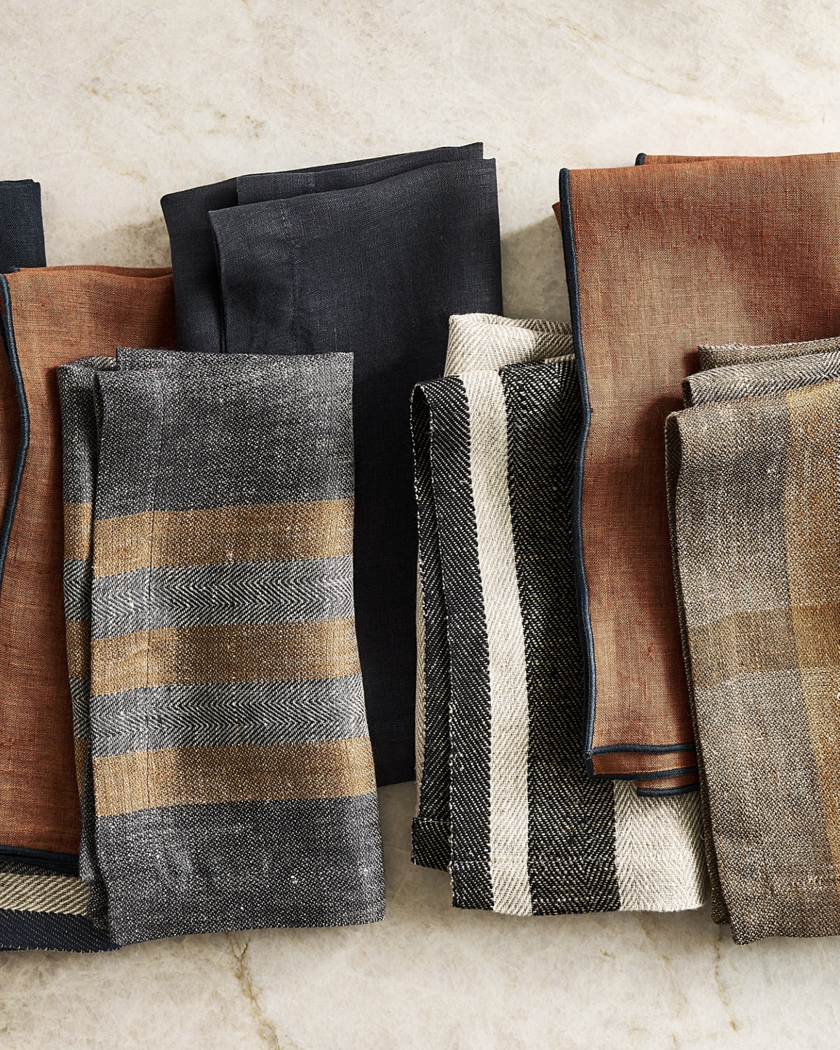 Hudson Grace fall linen napkins in striped and solid rust, black, and neutral colors