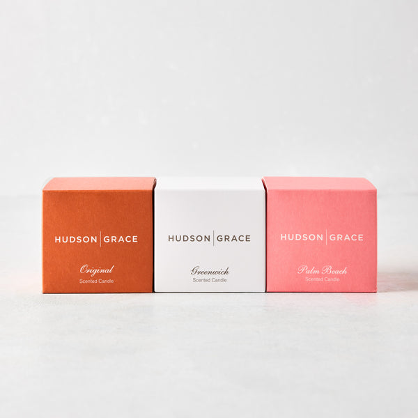 Hudson Grace votive gift set: three small square boxes in orange, white, and pink, labeled Original, Greenwich, Palm Beach.