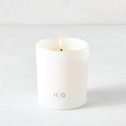Hudson Grace Greenwich Scented Candle, single wick, in a white frosted glass vessel with "HG" logo.