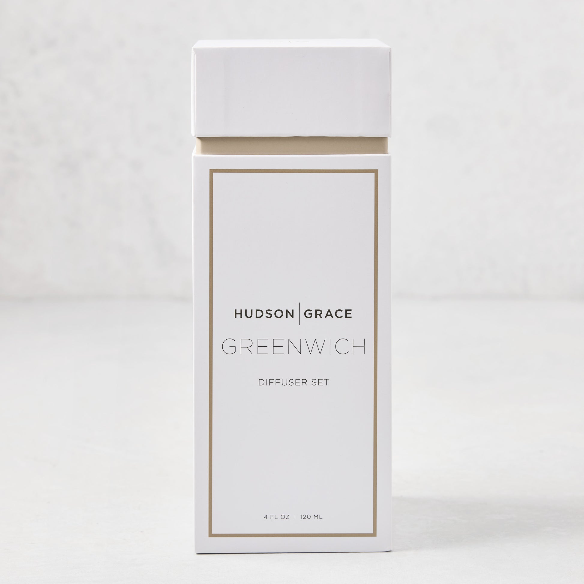 Hudson Grace Greenwich Scented Reed Diffuser set in a white box with gold trim, 4 fl oz.