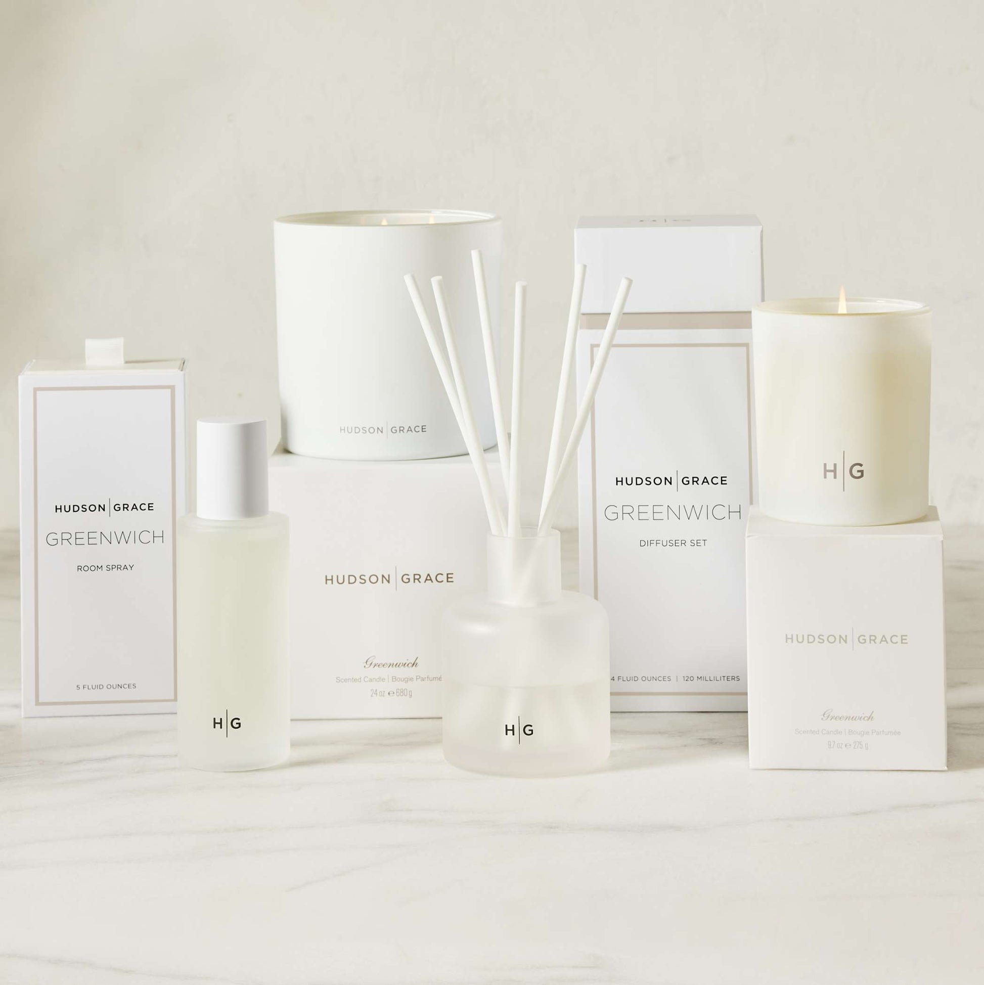 Hudson Grace Greenwich scented room spray, candle, and diffuser set with white bottles and packaging.