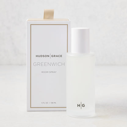 Hudson Grace Greenwich Room Spray: frosted glass bottle, white cap, next to white box with gold ribbon.