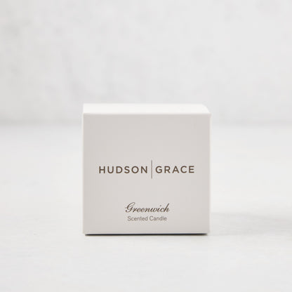 Hudson Grace Greenwich Scented Votive candle in a white gift box with brown text.