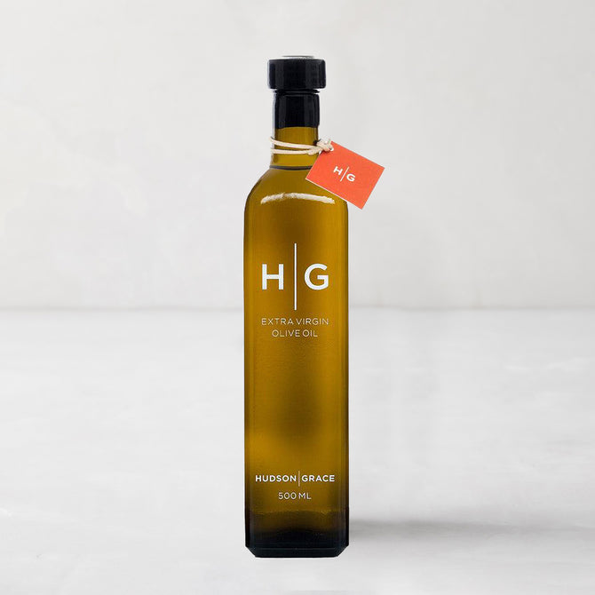 Hudson Grace 500ml extra virgin olive oil in a dark amber glass bottle with a black cap and orange tag.