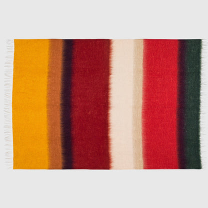 Hudson Grace Mantas Ezcaray Matisse mohair throw blanket featuring a vibrant striped pattern in red, yellow, and green.