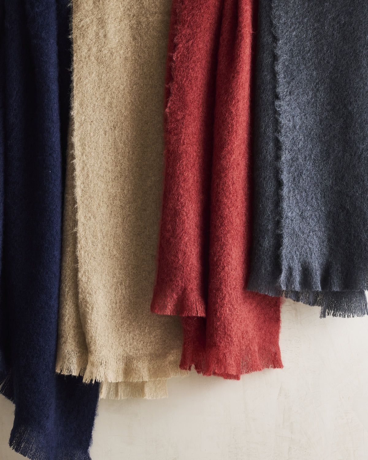 Hudson Grace mohair throw blankets with fringe in navy, beige, red, and gray