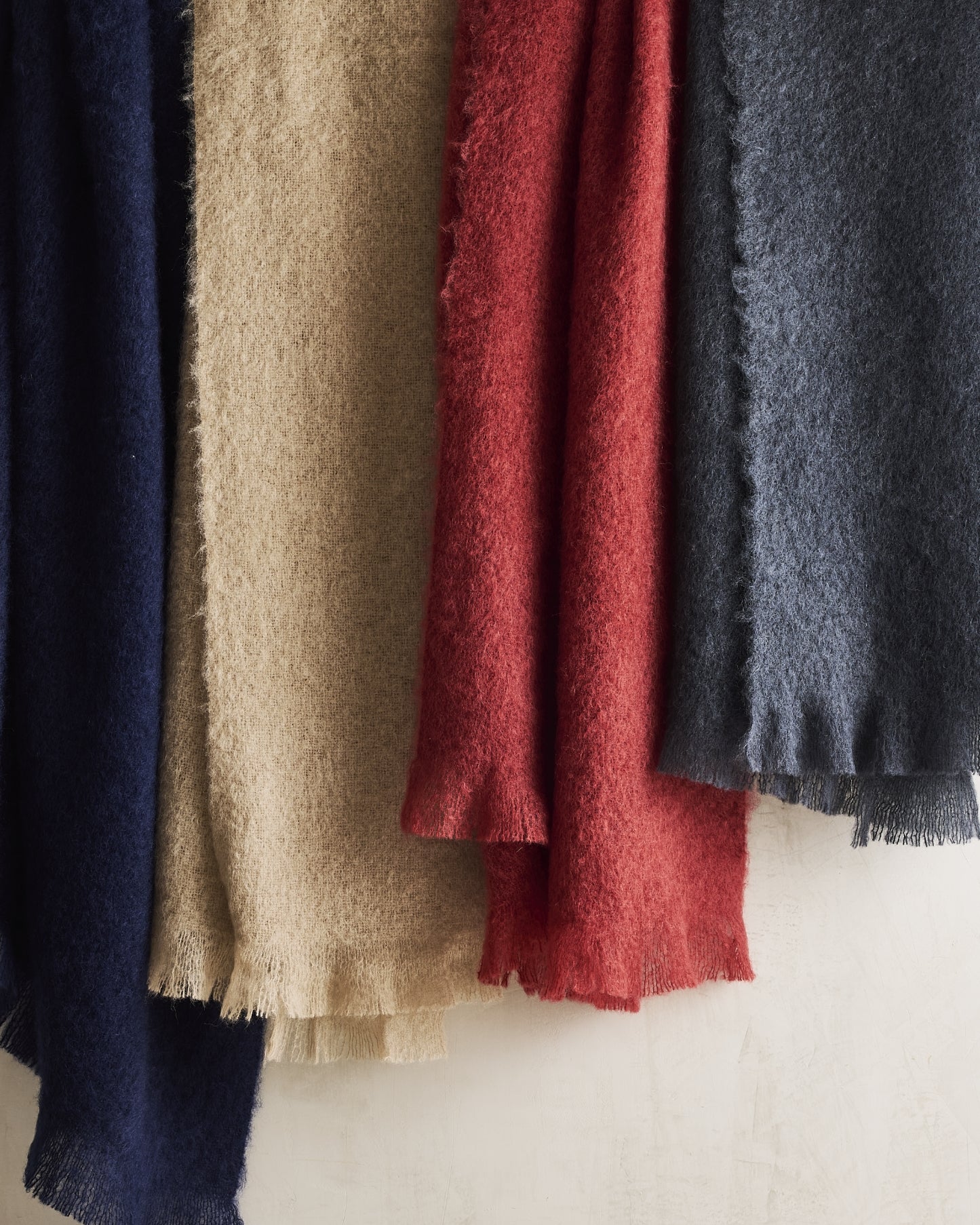 Hudson Grace mohair throw blankets with fringe in navy, beige, red, and gray