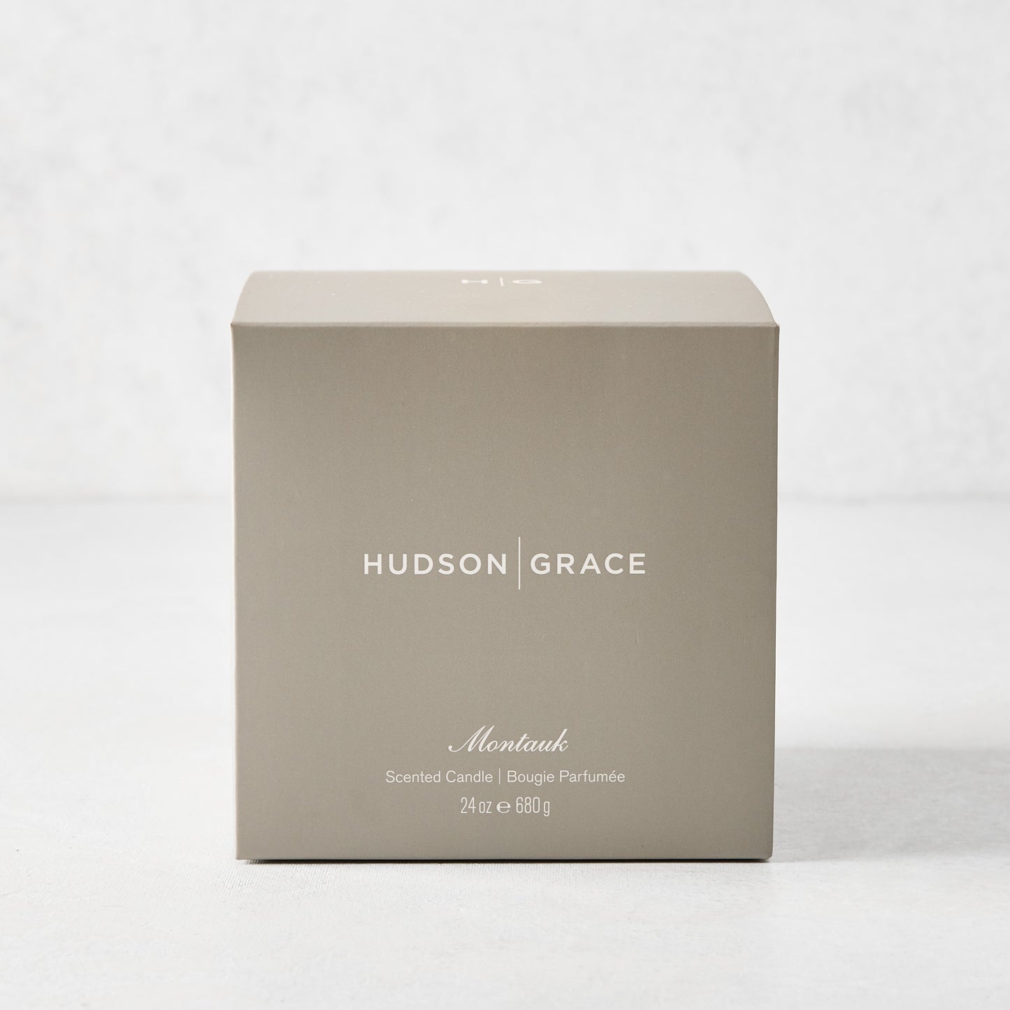 Hudson Grace Montauk 3-Wick Scented Candle in an elegant light brown gift box with white text.