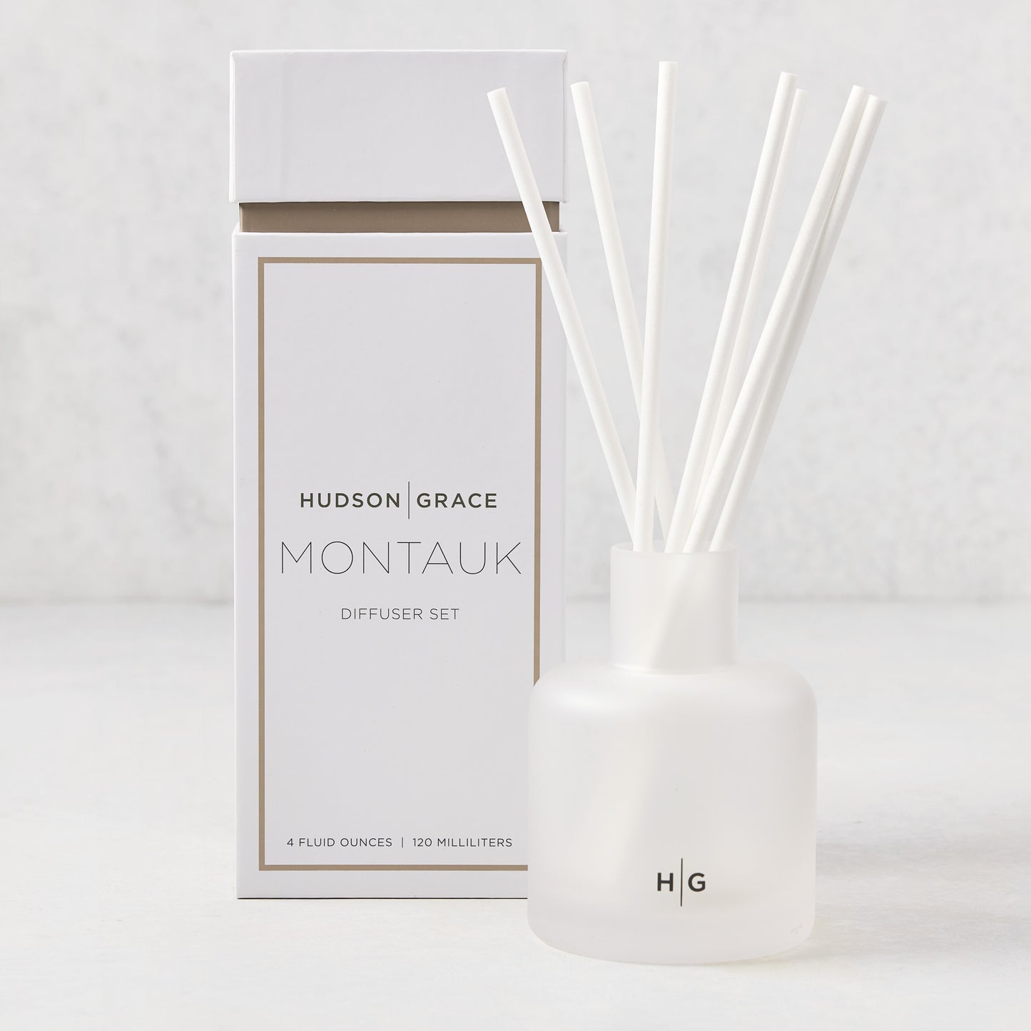 Hudson Grace Montauk Scented Reed Diffuser set with white frosted glass vessel, reeds, and box.