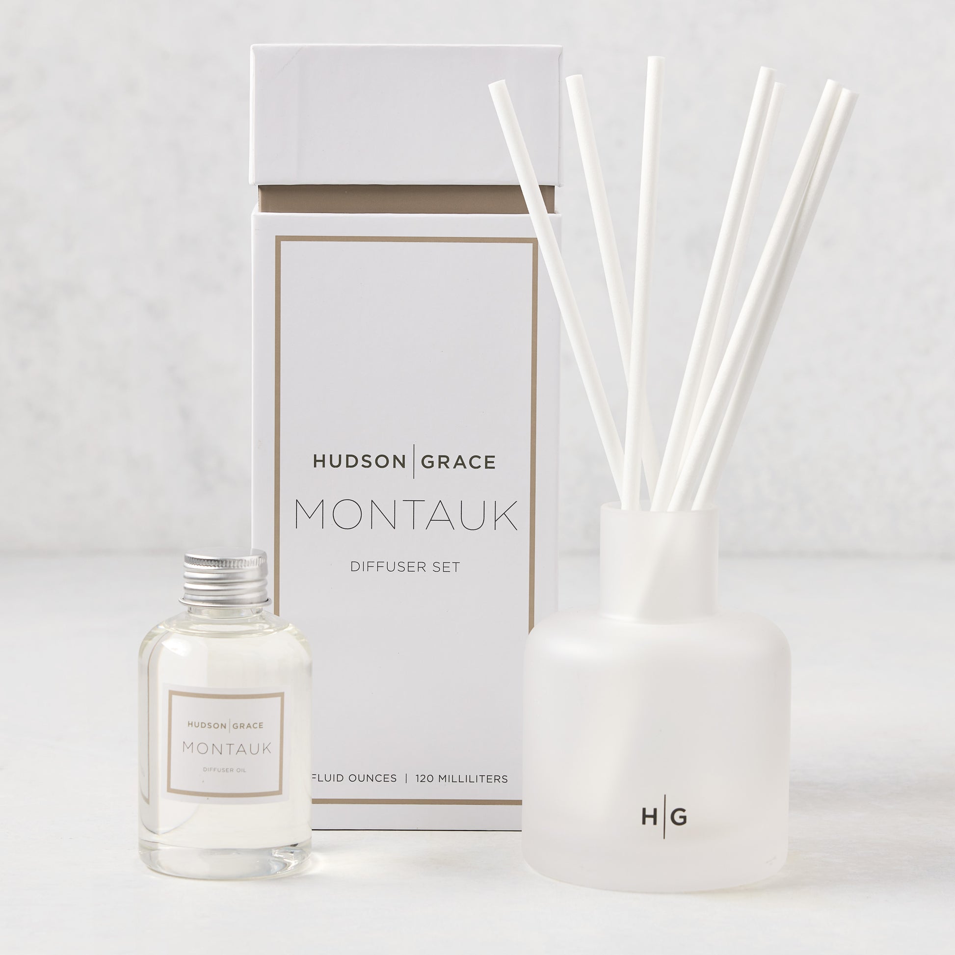 Hudson Grace Montauk diffuser set with white box, frosted glass vessel, reeds, and oil refill bottle.